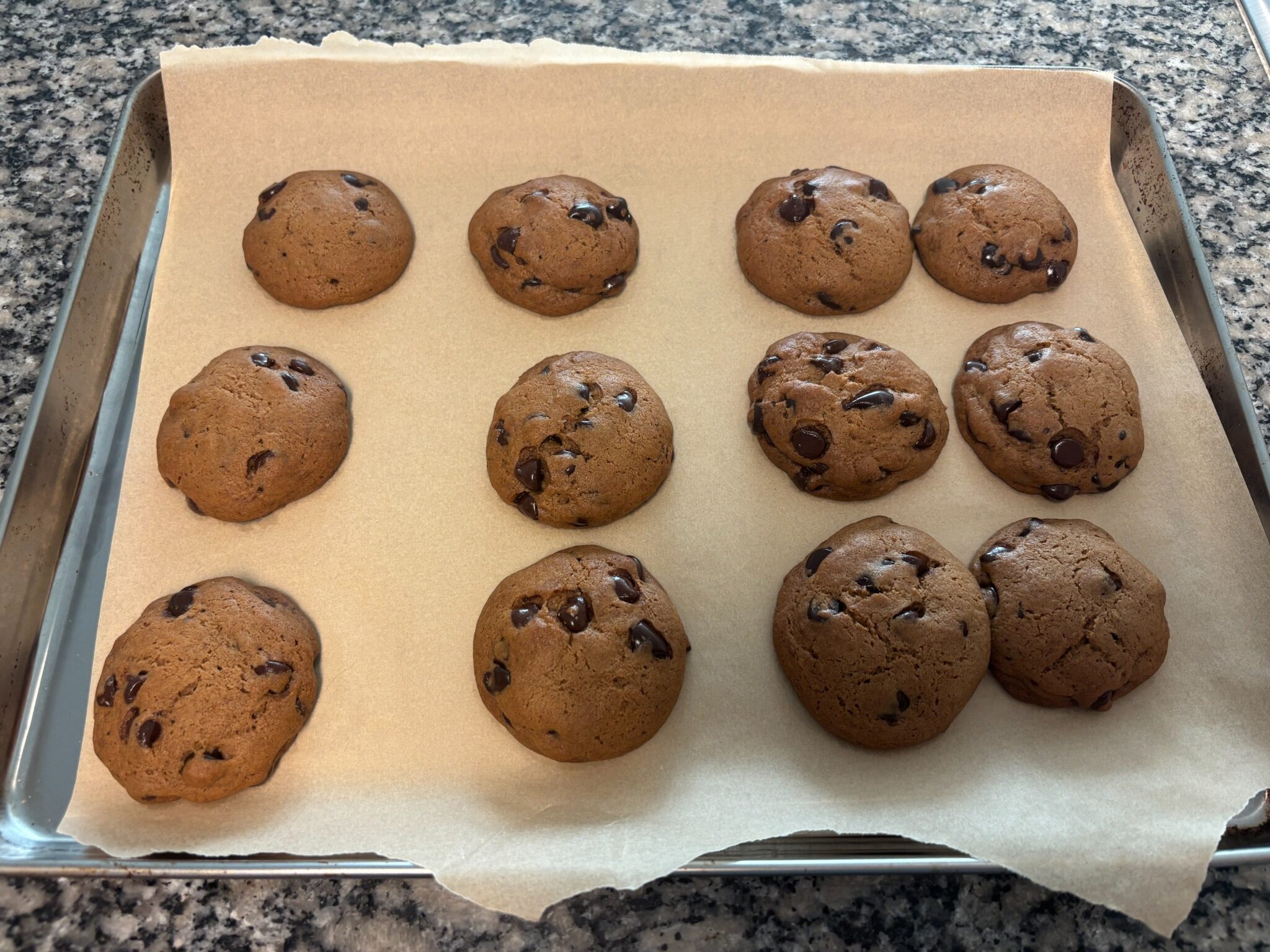 Brown butter chocolate chip cookies baked on a parchment-lined baking sheet