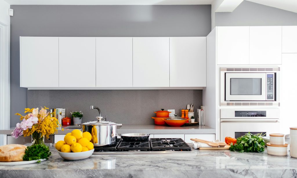 Kitchen with white cabinets and clear countertops